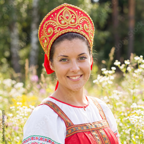 Close up portrait of a Russian beauty in a kokoshnik. National Russian-folk female costume