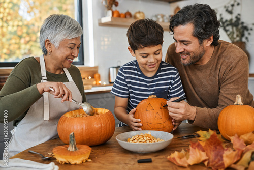 Multigenerational Family Preparing Halloween Pumpkins at Home