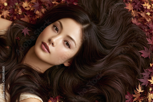 Autumn Beauty Portrait with Flowing Hair and Fall Leaves