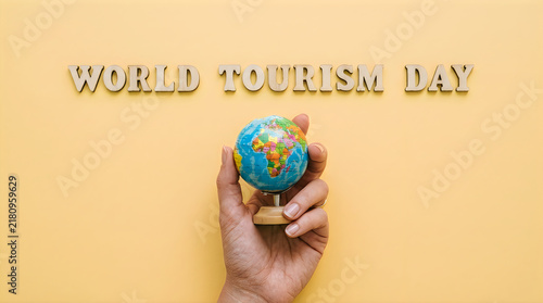 Hand holding small world globe for world tourism day with adventure, business