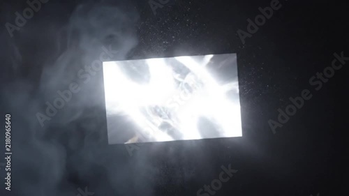 Abstract Light Effects Emerge and Expand Within a Rectangular Shape Illuminated Against a Black Background