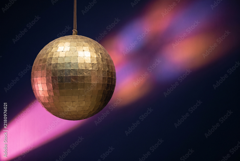 Fototapeta premium Mirrorball disco ball with colorful light beam for nightlife and party design