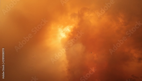 Dramatic Fiery Orange Clouds Illuminated at Sunset, Intense Sky Formation Resembling Smoke or Fire, Moody Atmospheric Nature Background for Weather and Disaster Concepts