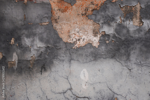 Peeling Paint on Textured Concrete Wall with Cracks