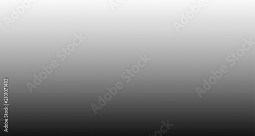 Abstract grey gradient background with smooth transition from white to dark charcoal black.