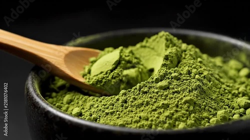 Green Tea Powder in Black Bowl with Wooden Spoon. 4K Video