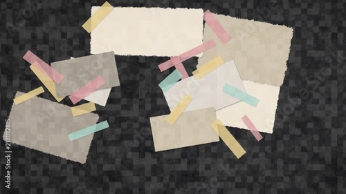 Stop motion animation of torn paper scraps and colorful washi tape strips shifting on a dark textured background