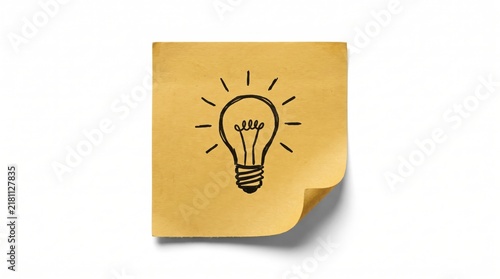 Hand drawn light bulb icon on a yellow sticky note paper