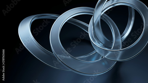 Three polished silver rings overlap in a subtle, modern arrangement.