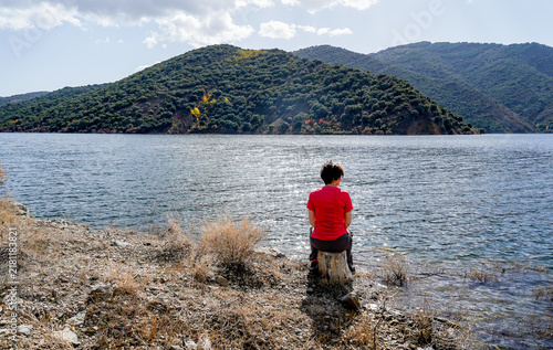 Woman contemplating cidacos dam reservoir in la rioja
