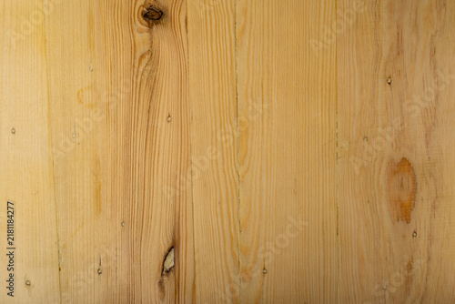 Natural light pine wood texture background with vertical grain patterns and knots, suitable for design and copy space.