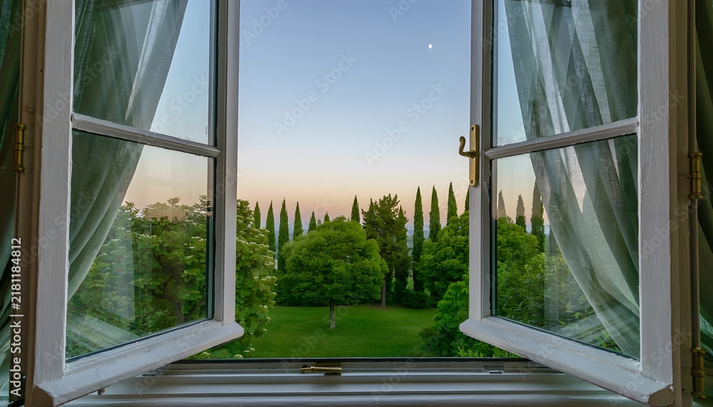 Fototapeta premium Open Window Looking Out to a Lush Green Garden and Cypress Trees at Sunset
