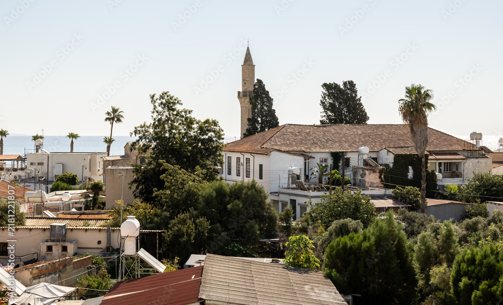 Obraz premium Larnaca, Cyprus, August 30, 2026 : A view from a window onto the rooftops of houses in the old historical district of Larnaca in Cyprus