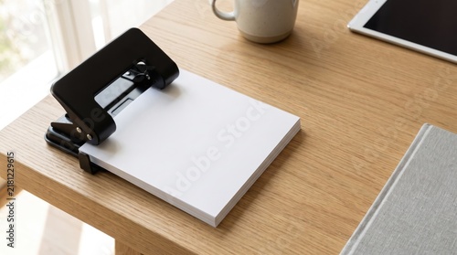 Black Paper Punch on Wooden Office Desk with Blank Documents