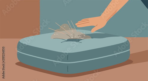 Hand touching scattered material on a cushioned surface