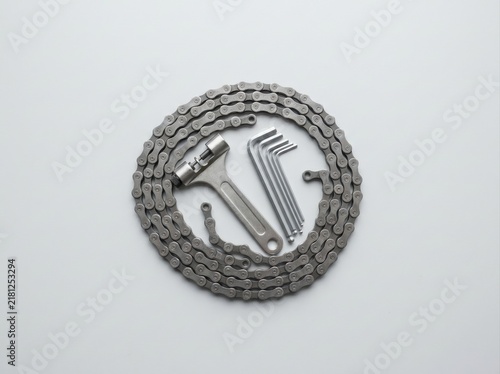 bicycle chain and repair tools Bicycle maintenance tools including chain, wrench, and hex keys on white background.
