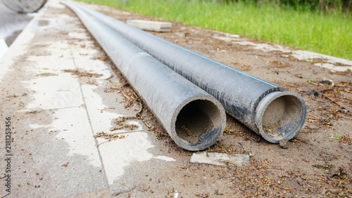 Heavy plastic pipes stored outdoors for underground utilities, drainage systems and infrastructure construction projects