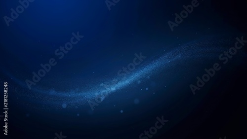 Wavy blue light trail with glowing particles on dark background