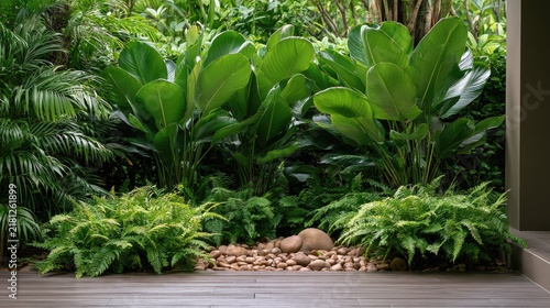 Lush Green Tropical Garden Scene with Ferns and Tropical Plants Surrounded by Smooth Stones in a Serene Outdoor Setting