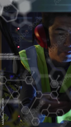 Animation of data processing against asian male engineer using digital tablet working at server room