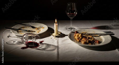 Empty dinner plates with lit candle on a table
