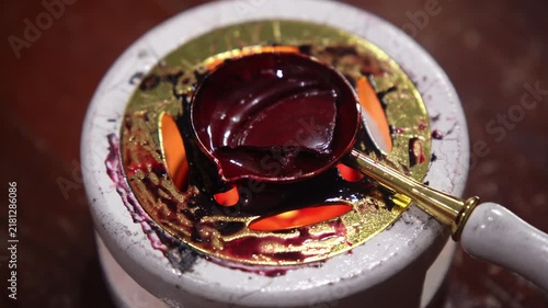 Close Up Macro Shot of Red Sealing Wax Melting Over Heat in a Spoon for Stamp Seals