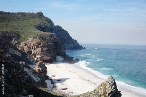 Canvas Print View from a steep cliff down to a white sand beach and turquoise surf on the Cap