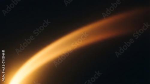 Abstract golden orange curved arc of planetary atmospheric glow isolated on deep dark void space background.