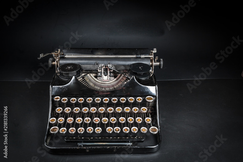 Fotografie Vintage typewriter machine on a dark low key background