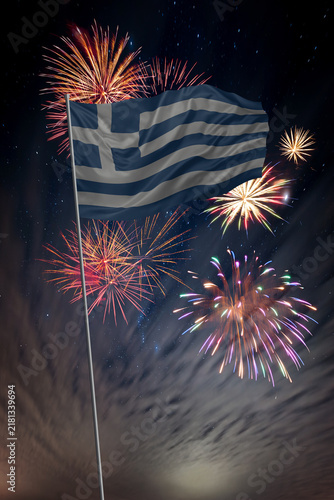 Waving National flag of Greece and holiday fireworks in night sky
