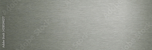 Brushed metal texture background, silver stainless steel surface with horizontal grain, industrial gray metallic plate for tech design, sleek chrome aluminum finish for modern backdrop