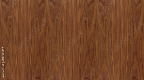Warm American walnut wood panel texture with symmetrical bookmatched cathedral grain, ideal for mid-century product stage mockups, 3D luxury interior material mapping, and executive background design.