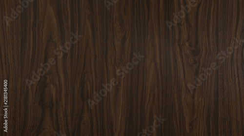 Dark smoked walnut wood texture with fine vertical wavy grain and deep espresso tones, ideal for moody executive product stage mockups, 3D luxury interior material mapping, and dark background design.