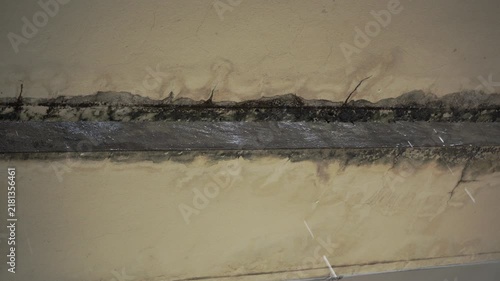 Rainwater Dripping from Damaged Concrete Ceiling with Black Mold and Water Damage Stains