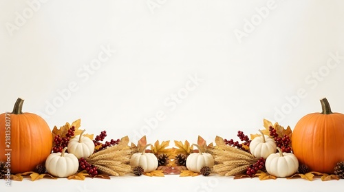 Festive autumn background featuring pumpkins and colorful fall leaves with copy space for seasonal text