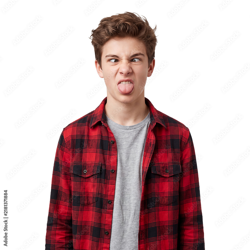Obraz premium Funny teenage boy transparent background silly face tongue playful portrait Youth in a red plaid shirt crosses his eyes and sticks out his tongue for humor mischief comedy and lighthearted campaigns