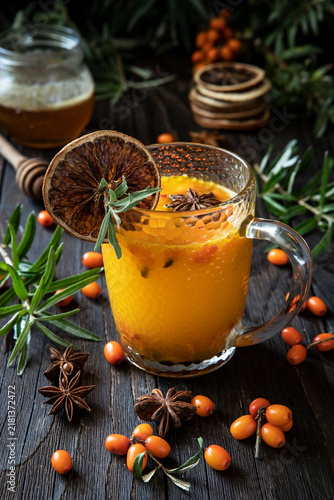 Vitamin tea from sea buckthorn with  anise on wooden table