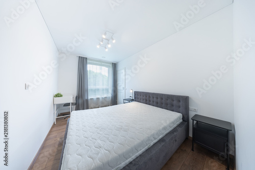 Minimal Modern Bedroom With Upholstered Bed and Mattress in Bright White Interior