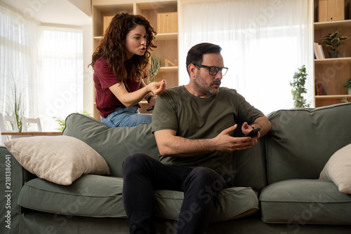 фотографія Jealous wife reacting to hidden phone messages from her husband