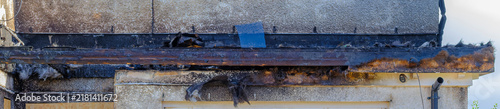 Konstfotografi Burnt roof shows damage after destructive fire event