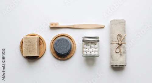 Eco-Friendly Bathroom Essentials: A thoughtfully curated collection of sustainable personal care items, including a bamboo toothbrush, natural soap, solid shampoo bar, and rolled towel.