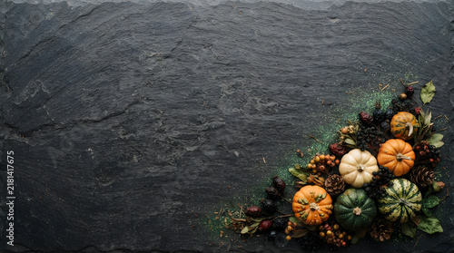 Colorful flowers with pumpkins on dark textured background