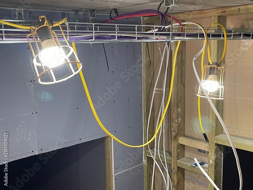 Construction site temporary lighting and electrical wiring installation in progress