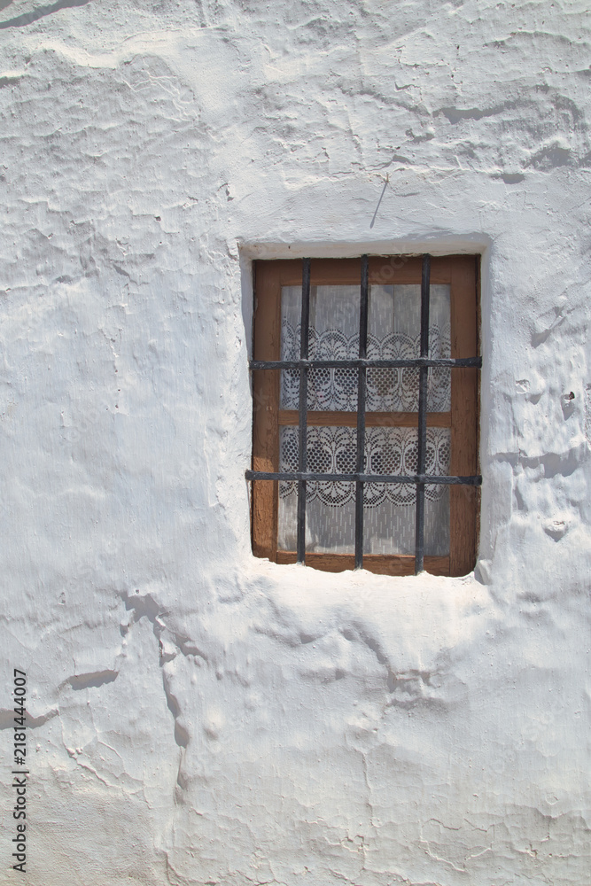 Fototapeta premium Old white window and whitewashed wall, typical of the 1950s.