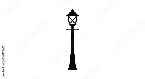 Vintage street lamp stands as a dark silhouette against a white background