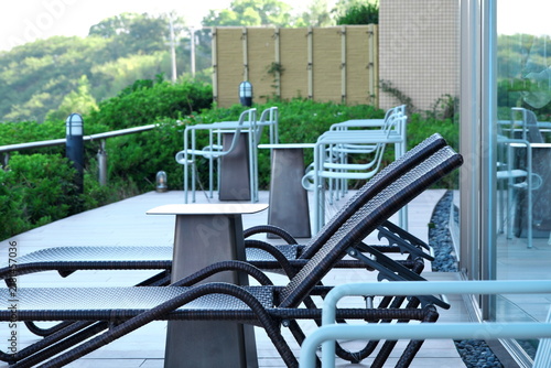Fototapeta Outdoor terrace with lounge chairs and tables for relaxation