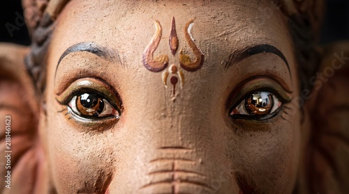 Close-up of Lord Ganesha's Eyes and Forehead with Traditional Markings and Reflections, Symbolizing Wisdom and Divine Presence