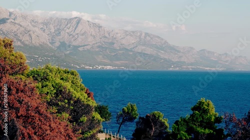 Scenic coastal mountains overlooking calm blue sea on summer day