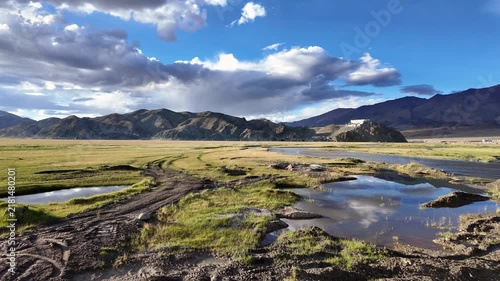 Hanle, India : Panoramic footage over hilltop Hanle gompa, a Tibetan Buddhist monastery in Hanle valley in Ladakh, India with reflection on the river and surrounded by beautiful landscape at sunset