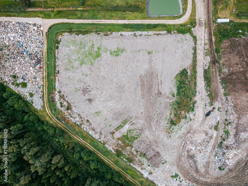 Aerial view of a large landfill site showing waste sorting areas, piles of debris, and surrounding forest landscape, Laidzes pagasts, Talsu novads, Latvia.